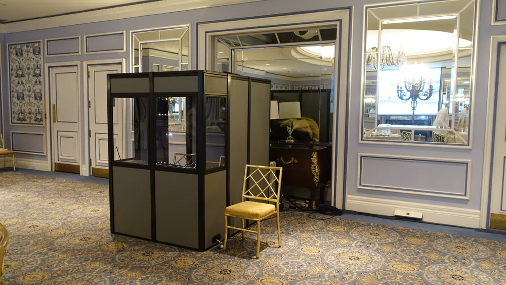 a full interpreter isolation booth set up in a fancy meeting room