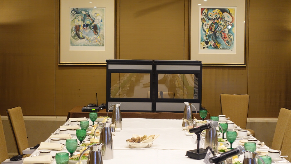 a tabletop interpreter booth set up in room with banquet style seating