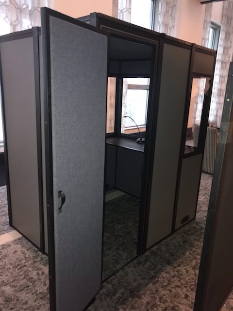 a picture of the compact-12 sound isolation booth with the door open