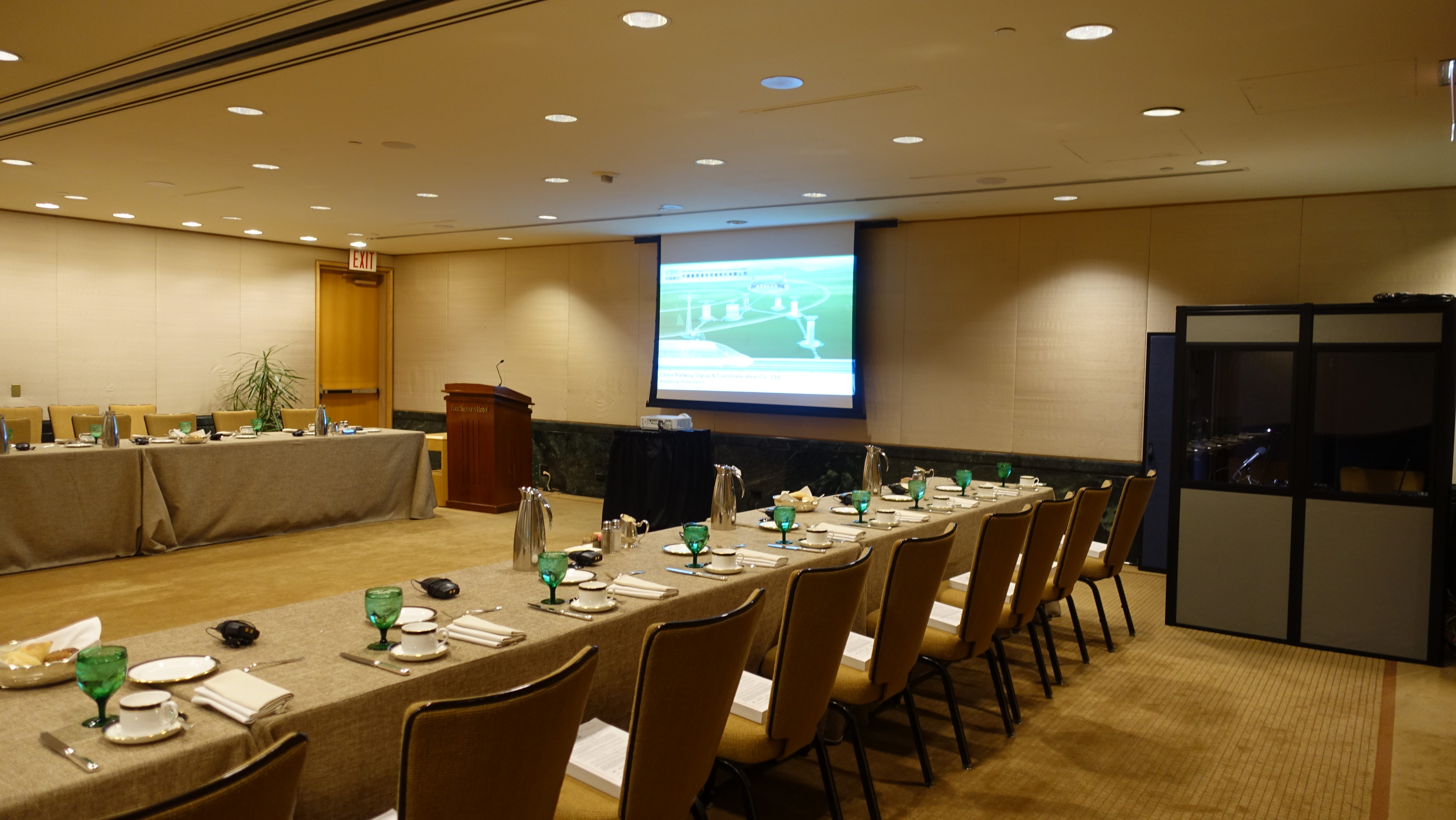 full booth in the corner of a meeting room with banquet style seating